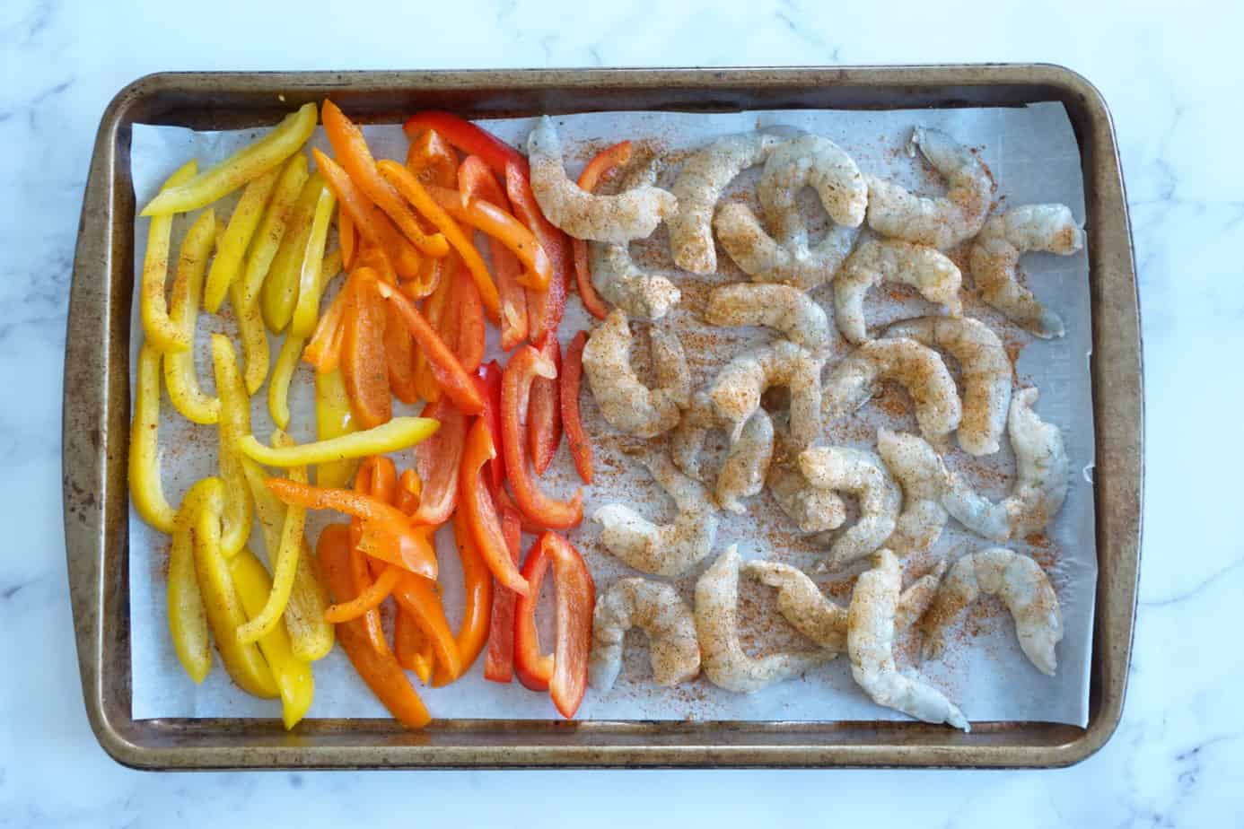 shrimp fajitas with seasoning, guacamole and cilantro before cooking