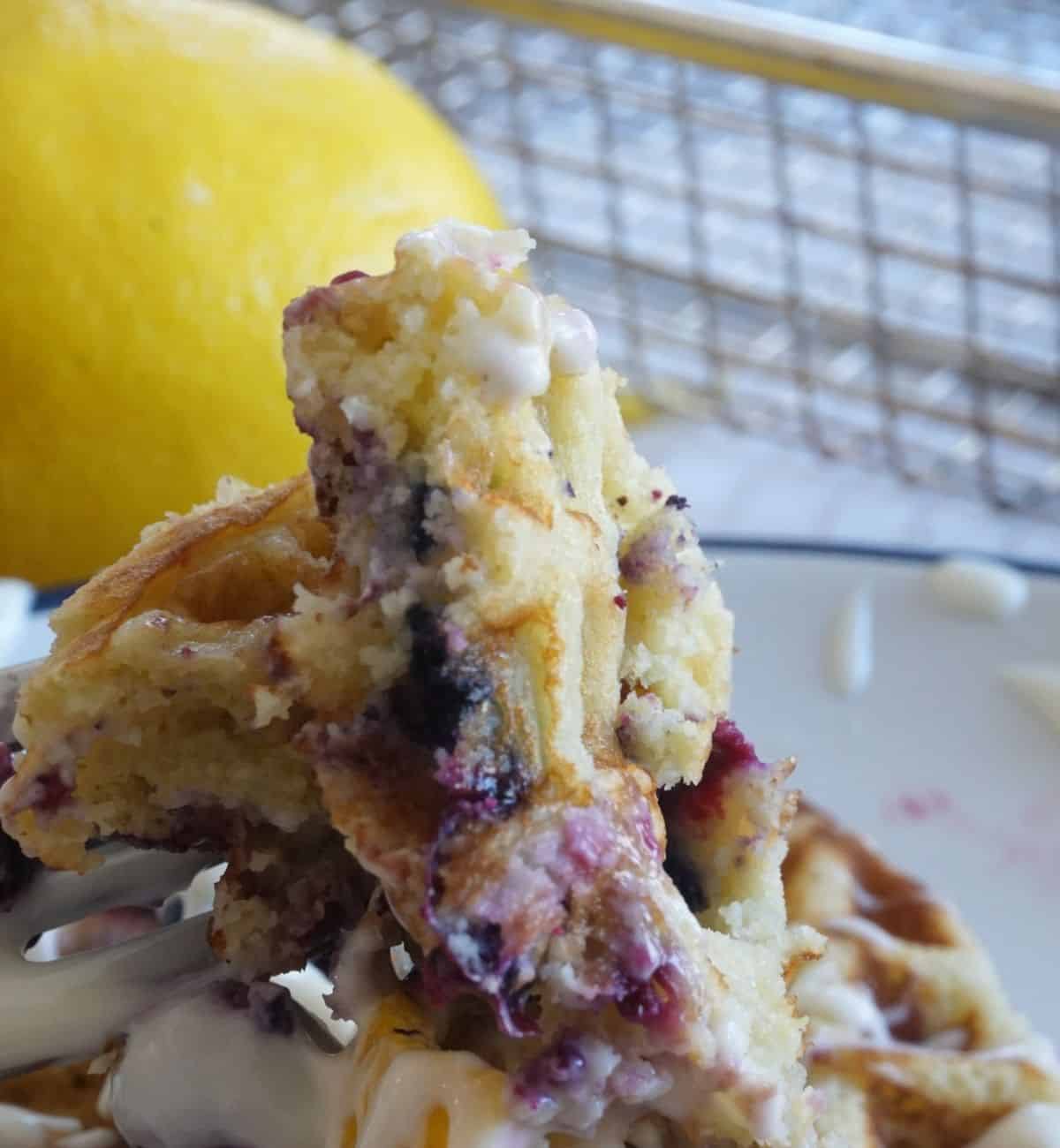 up close view of blueberry waffle cut open with fork