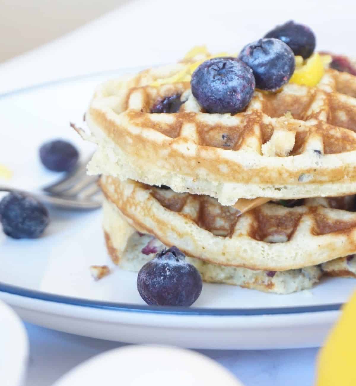 blueberry lemon waffles stacked on top of one another