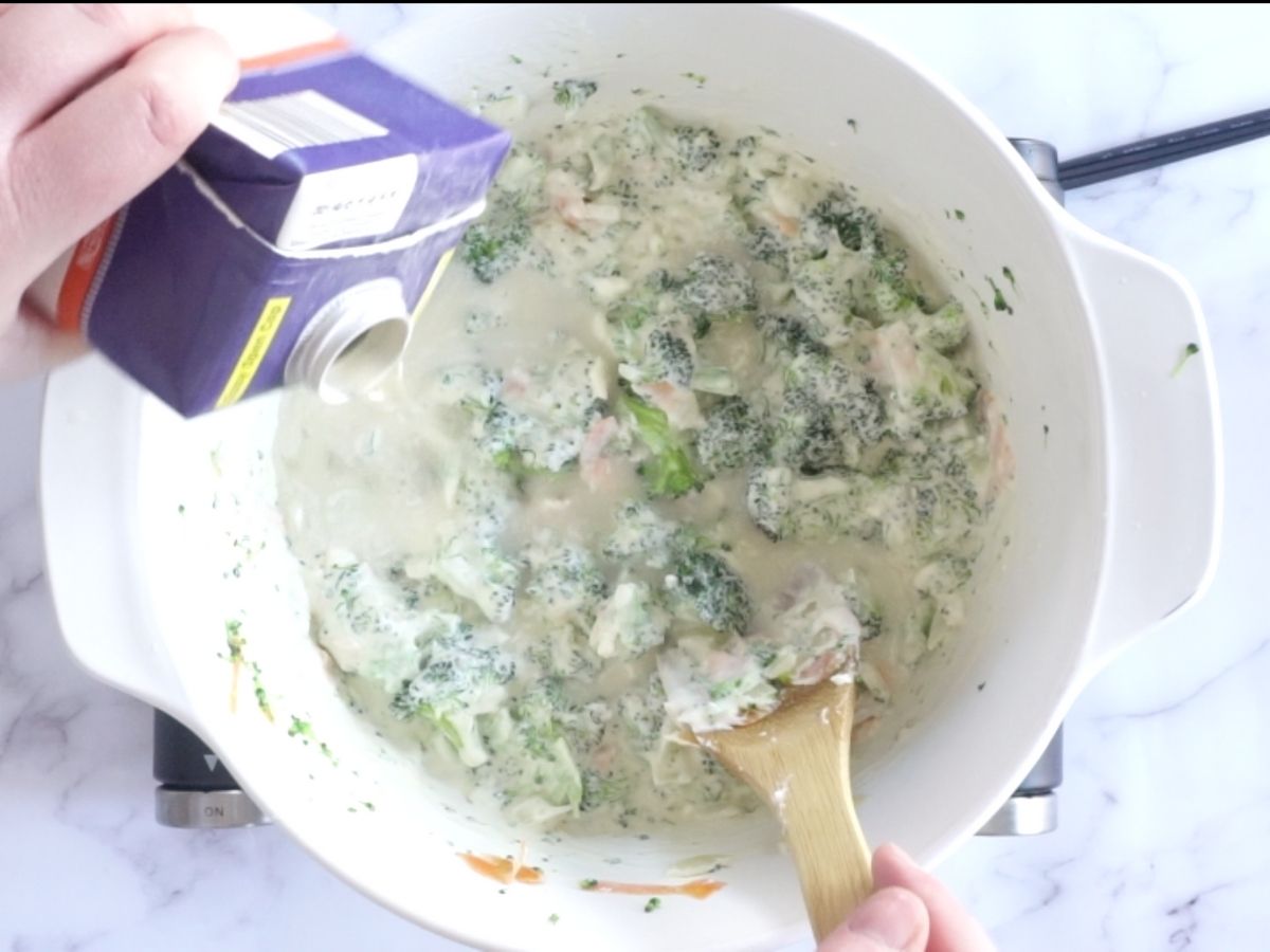 adding chicken stock to pot