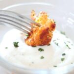 dipping cauliflower pizza wings into ranch dressing