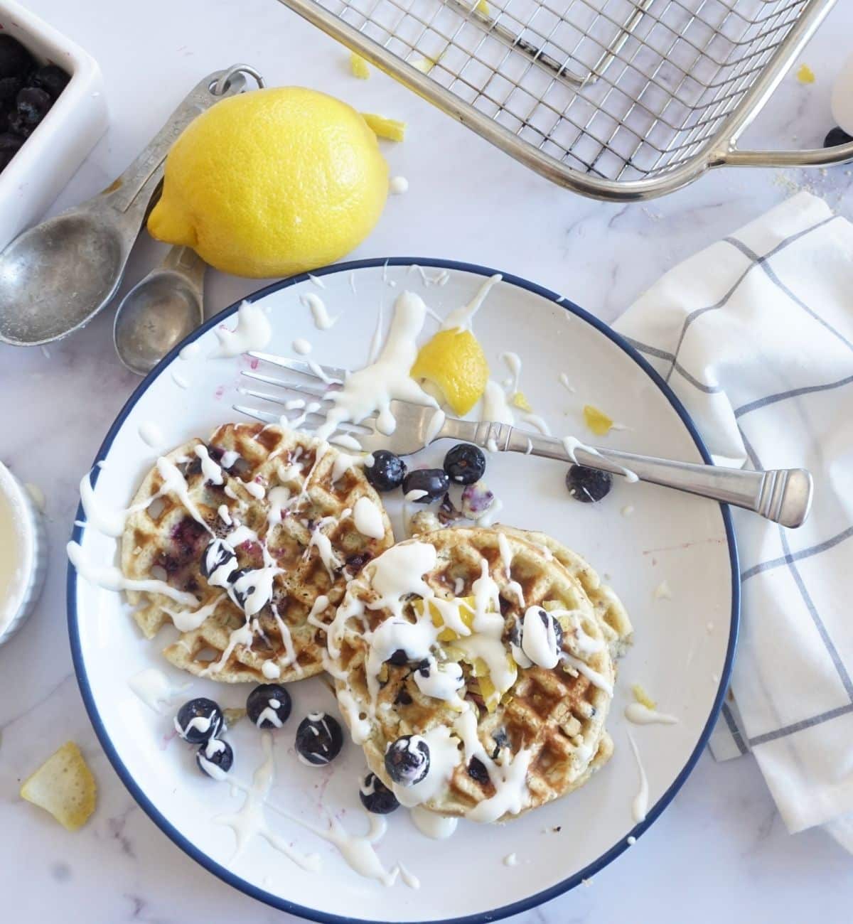 blueberry lemon waffles with cream cheese spread all over