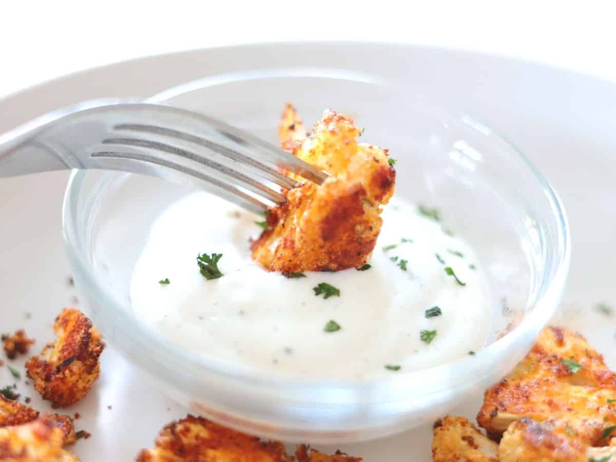 dipping cauliflower pizza wings into ranch dressing