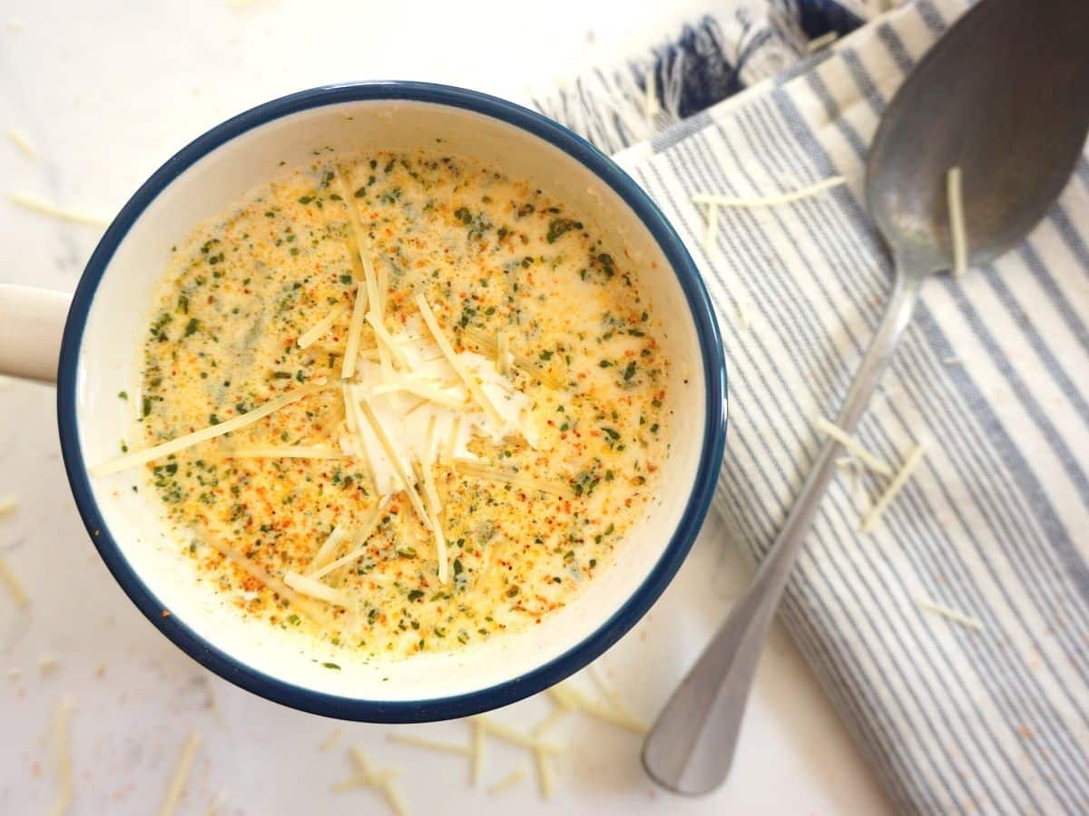 creamy crab soup with parmesan cheese on top