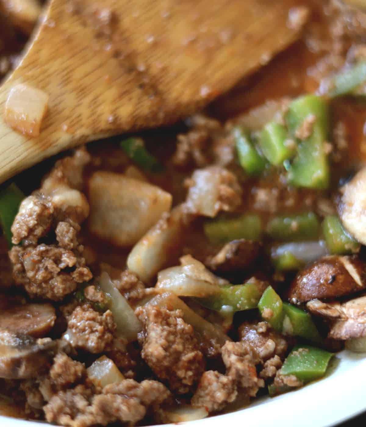 large view of flavorful casserole filled with mushrooms peppers and onions