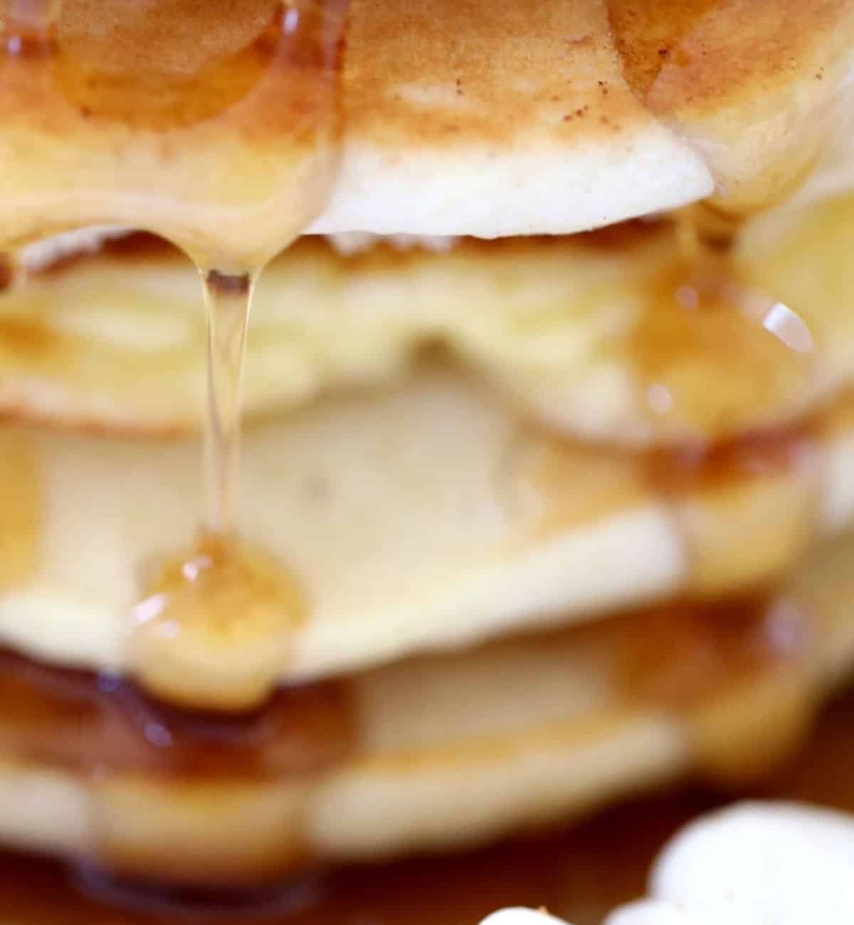 sugar free syrup dripping down keto cinnamon roll pancakes