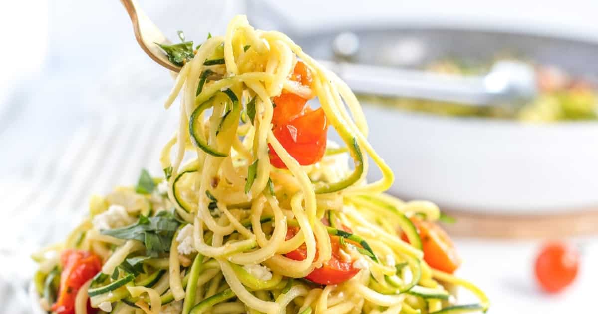 zucchini zoodle pasta with feta cheese and tomatoes