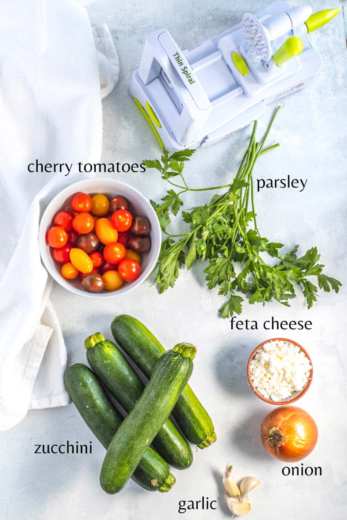 table with ingredients for a simple feta tomato zoodle pasta
