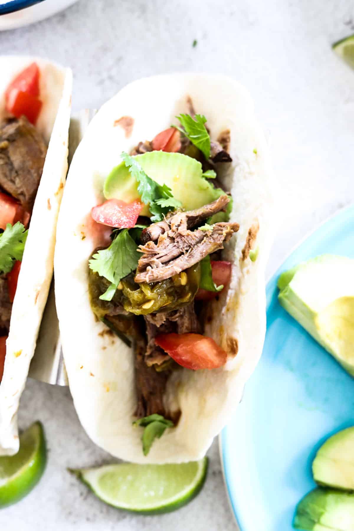 carne asada taco with tomato and cilantro