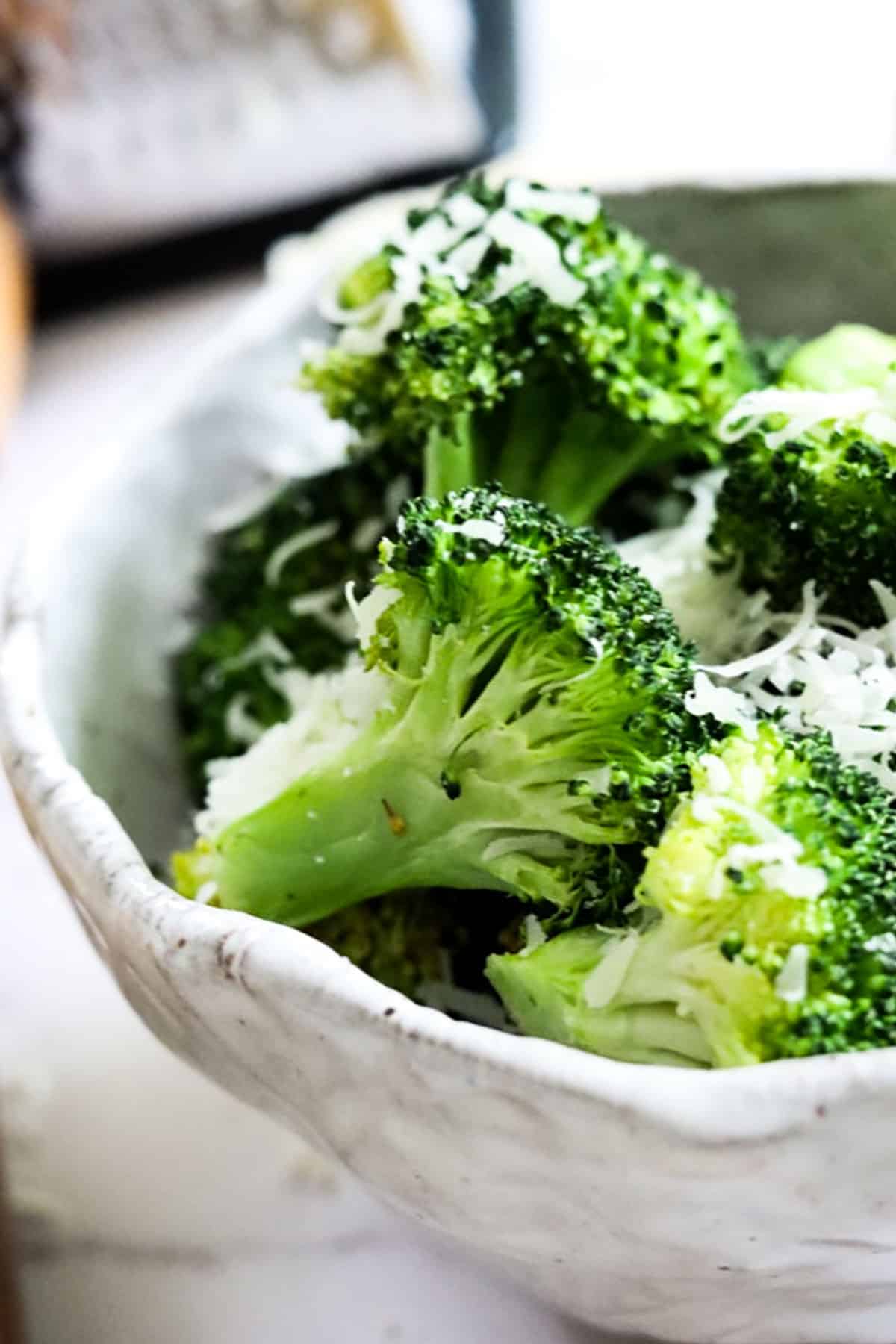 close up view of a broccoli floret in a bowl fresh from the air fryer