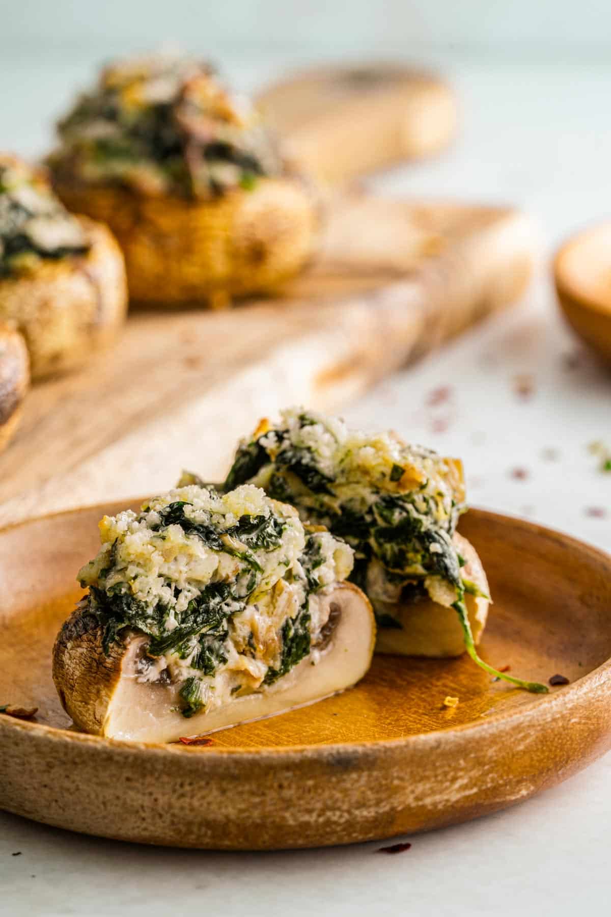 mushroom cut open revealing creamed spinach and parmesan cheese inside