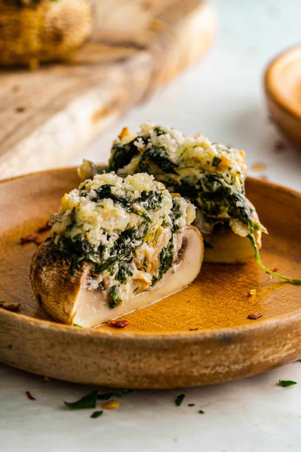 creamy spinach stuffed mushroom cut open stuffed with cream cheese and parmesan