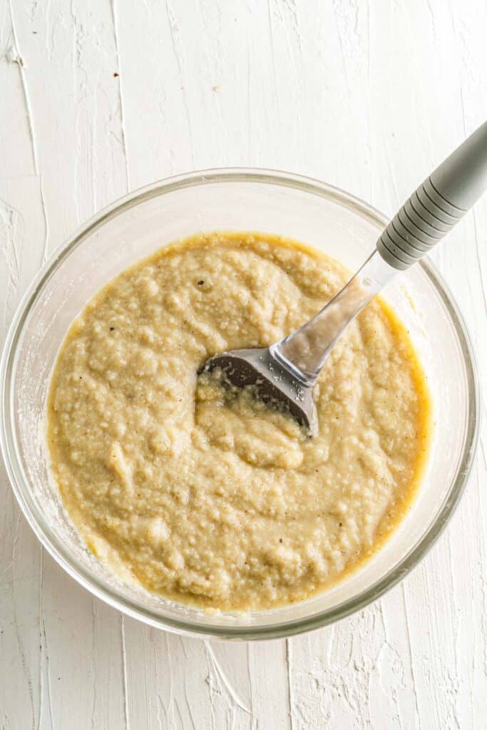 banana nut bread batter whisked in a bowl 