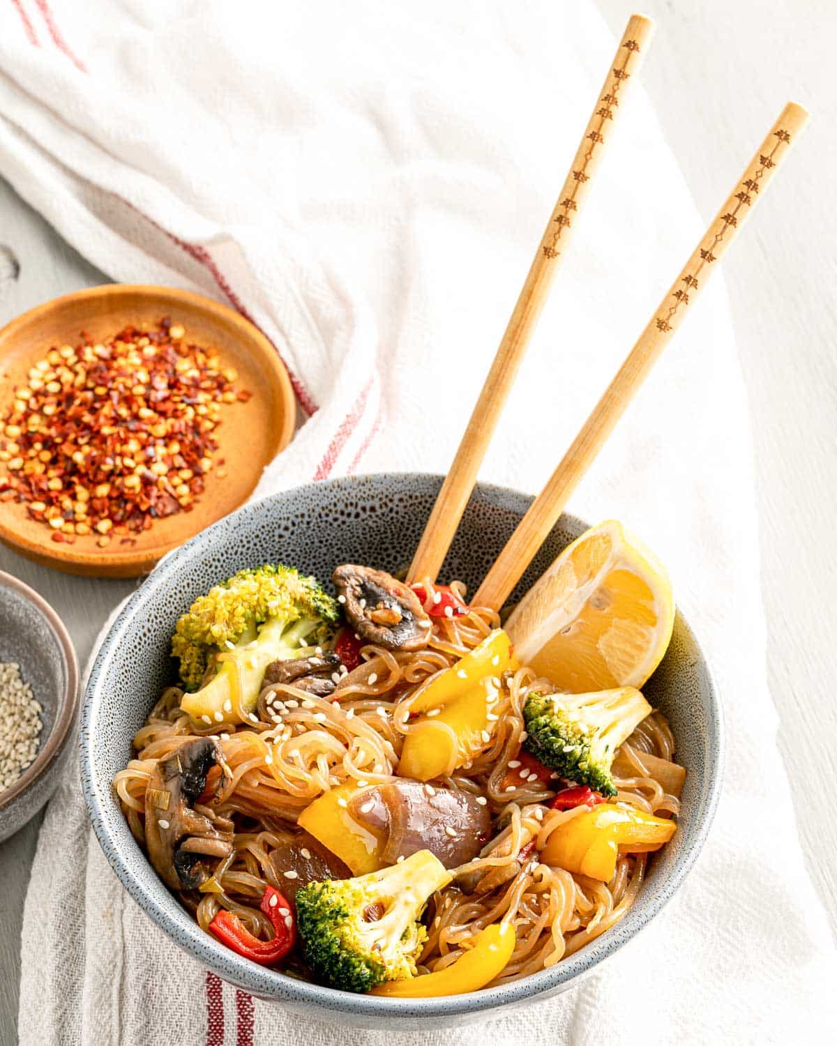 bowl of stir fry ingredients with chopsticks