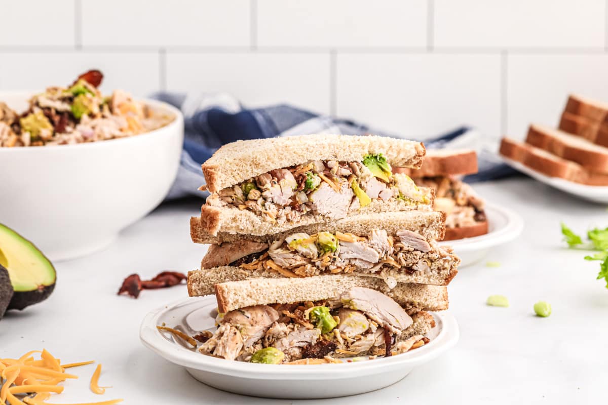 chicken salad sandwiches with bowl of ingredients avocado