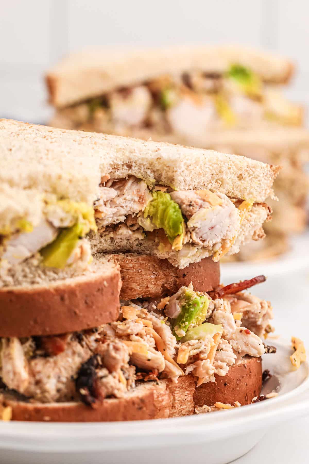 chicken salad sandwiches cut in half and stacked on top of one another