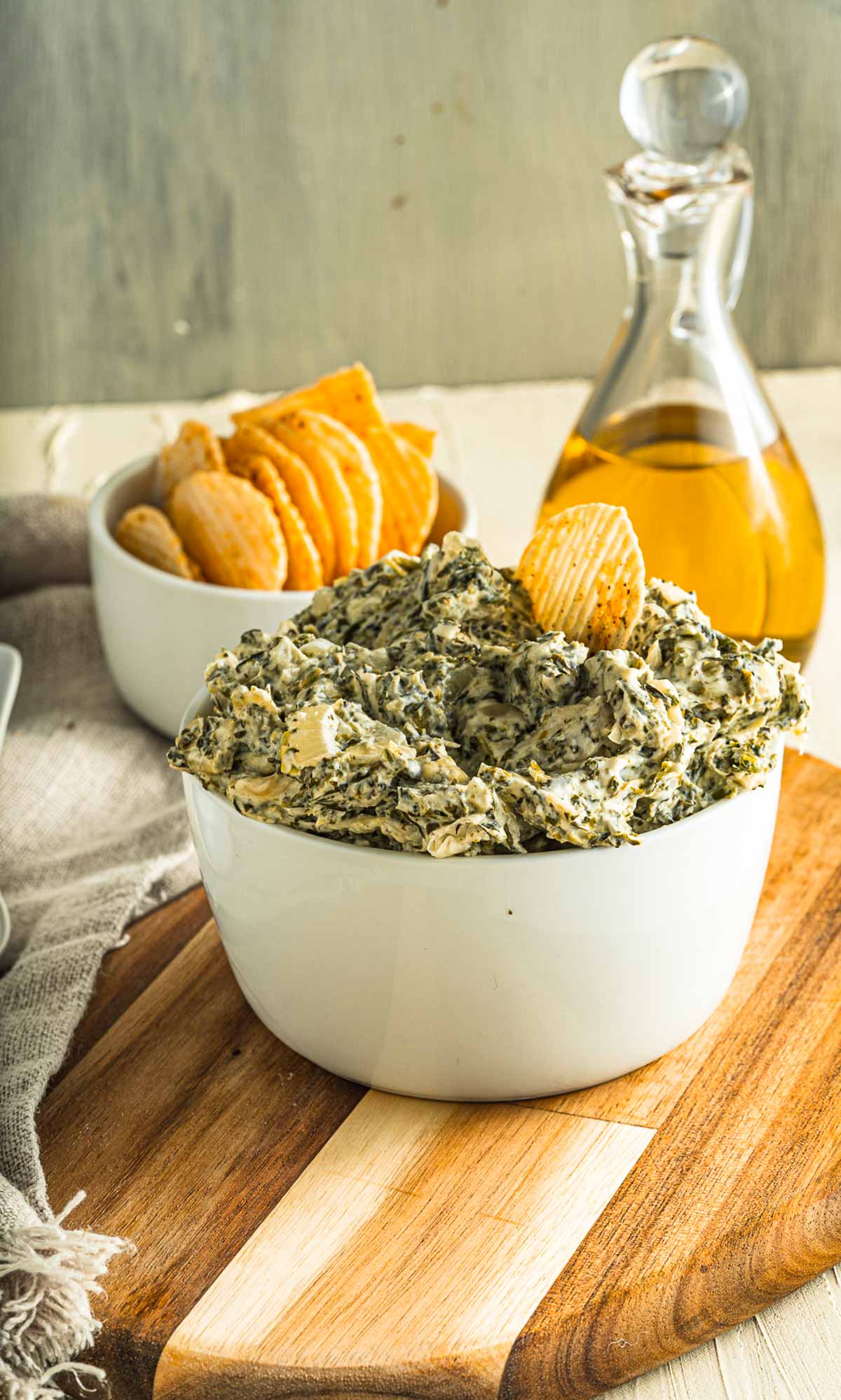 bowl of dip on a wooden board with olive oil