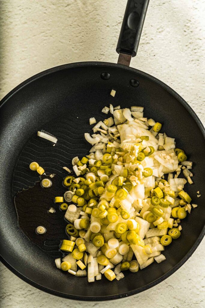 adding veggies to pan