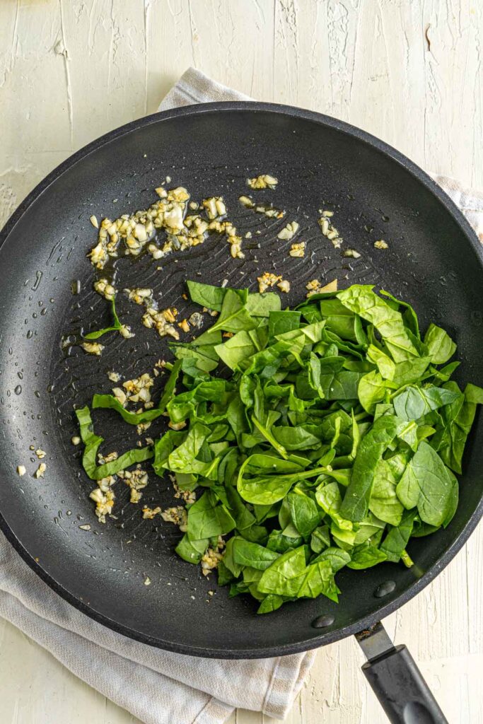 spinach and garlic sautéed in a pan