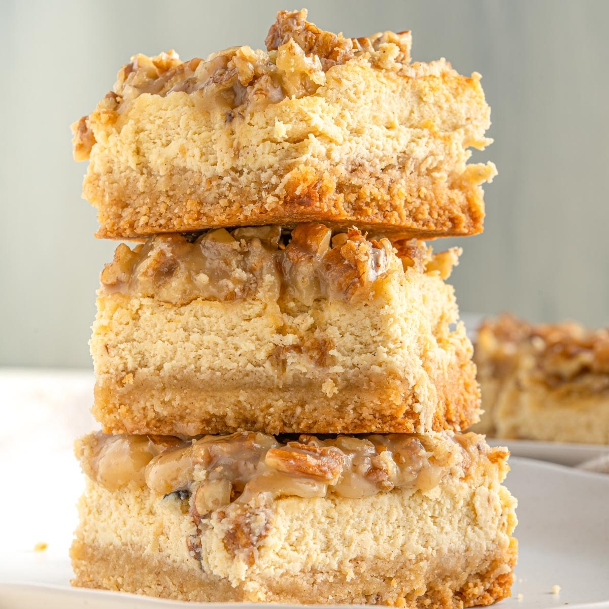 thick keto cheesecake bars stacked in a pile of three