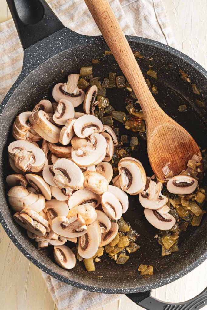 add in mushrooms to the pan and cook
