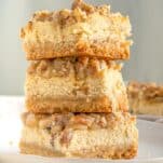 stacked pecan cheesecake bars showing the rich creamy insides