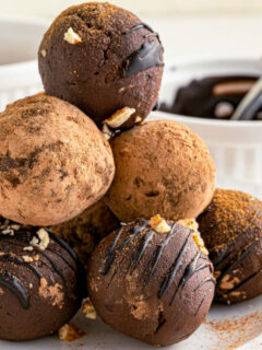 stack of round truffles with chocolate sauce in the background