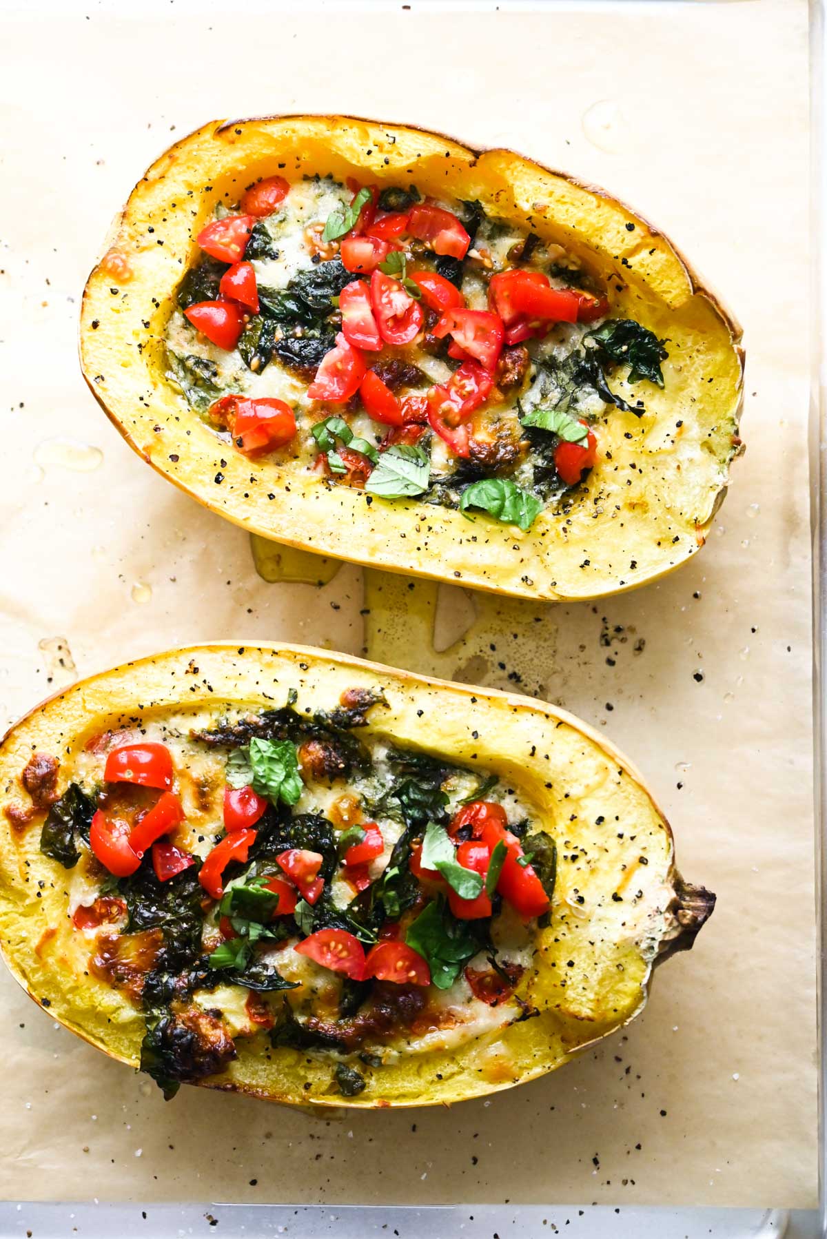 tomatoes and spinach inside spaghetti squash halves