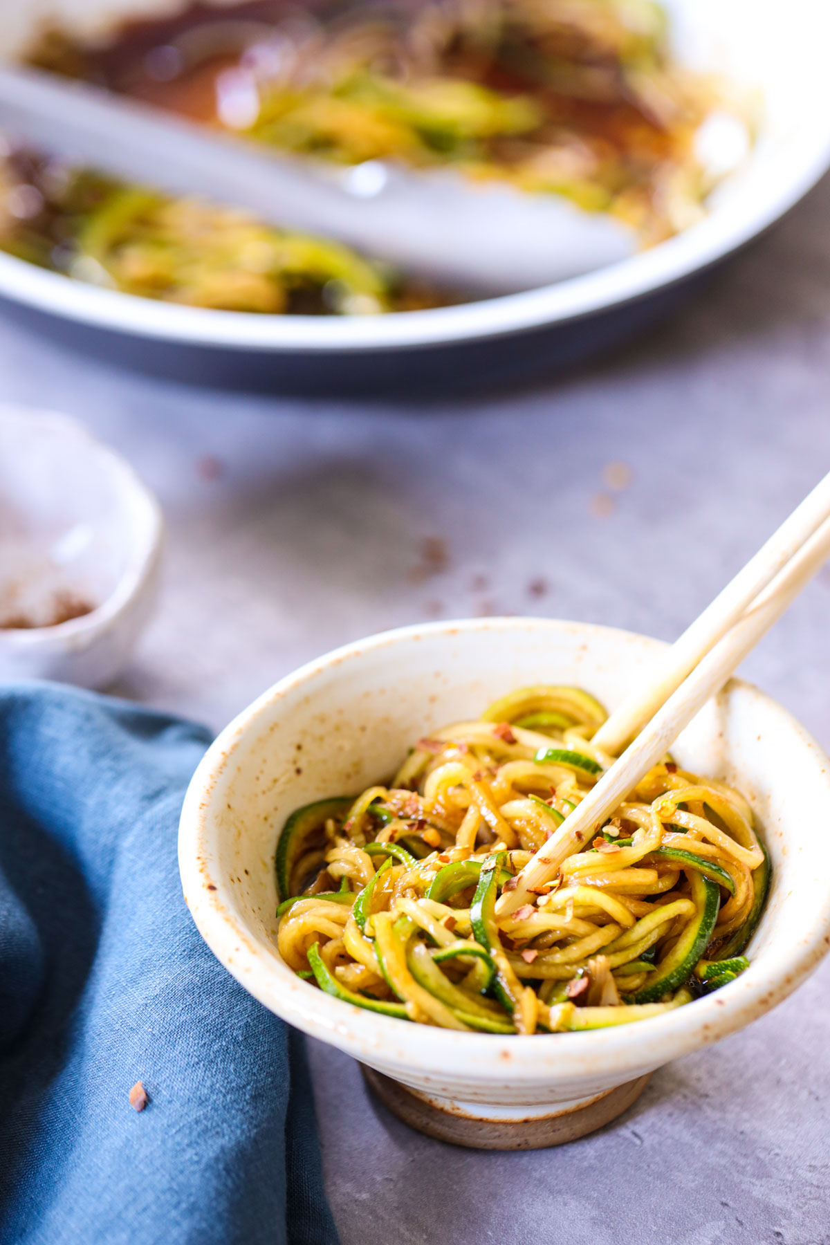 bowl of zoodle lo mein and a frying pan