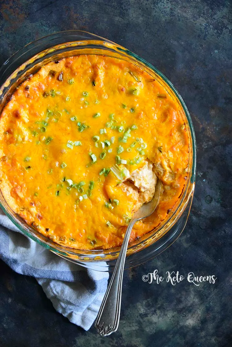 buffalo chicken dip in a bowl with green onion topping