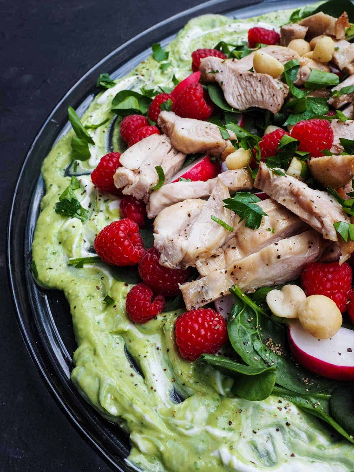 low carb chicken salad with berries, radish, spinach, and avocado