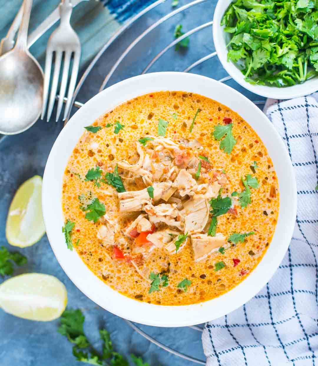 Mexican chicken soup with lime wedges and cilantro 