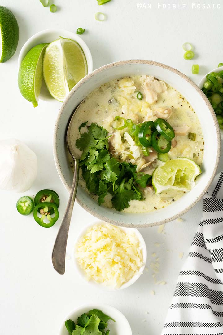 keto white chicken chili topped with cilantro, lime and jalapeño