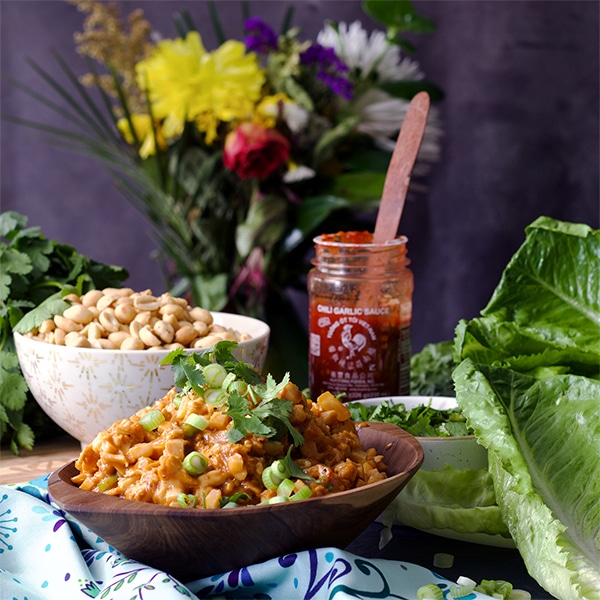 chicken lettuce wraps next to Sriracha sauce