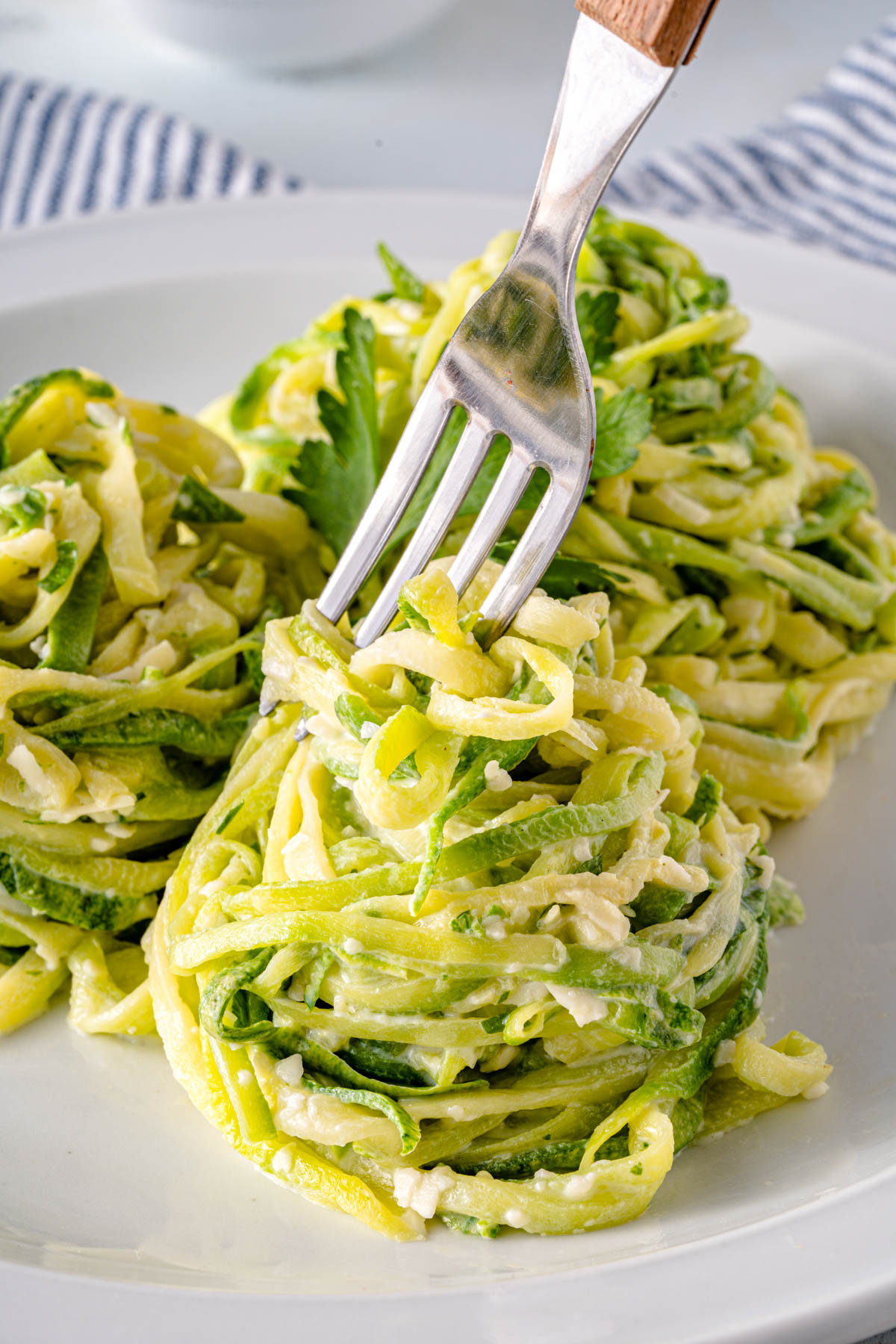 fork twirling a creamy zucchini pasta nest