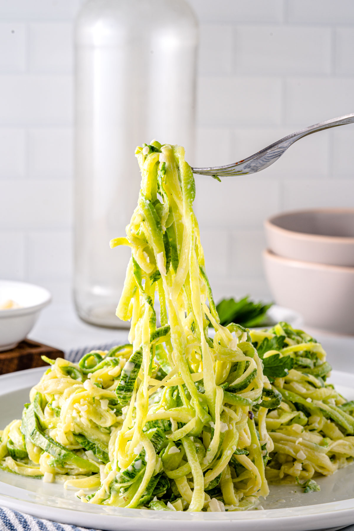 soft creamy zoodles lifted with a fork