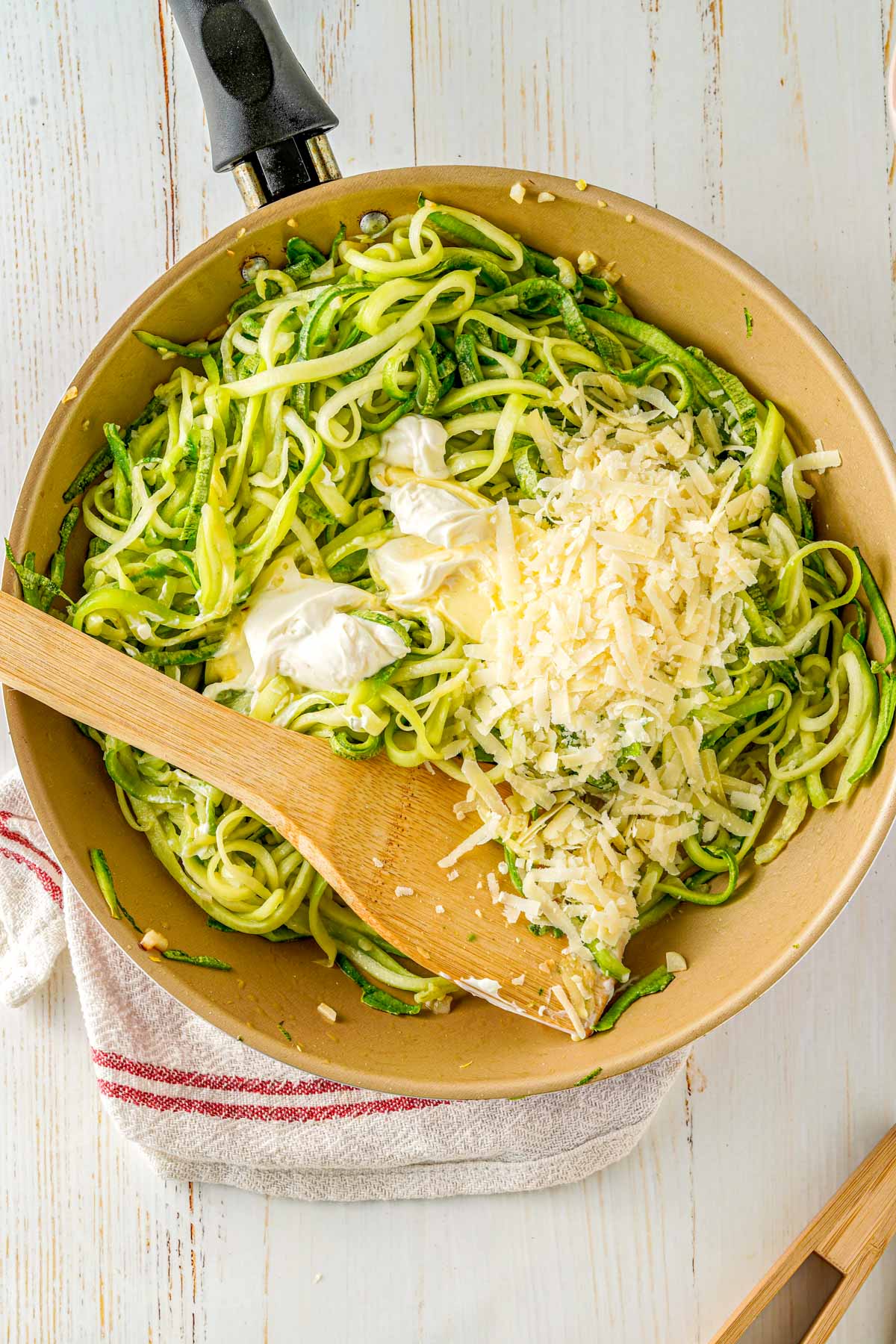 pan with zoodles and parmesan cheese