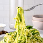 soft creamy zoodles lifted with a fork