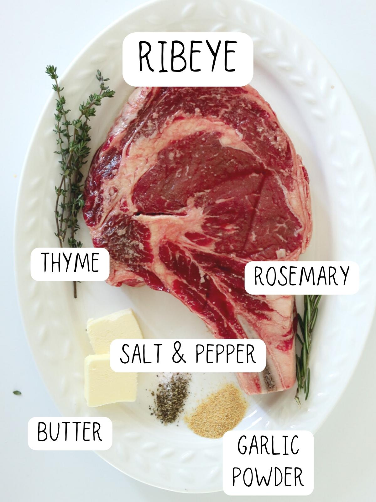 ingredients for air fryer ribeye, including ribeye steak, garlic powder, butter, rosemary and thyme