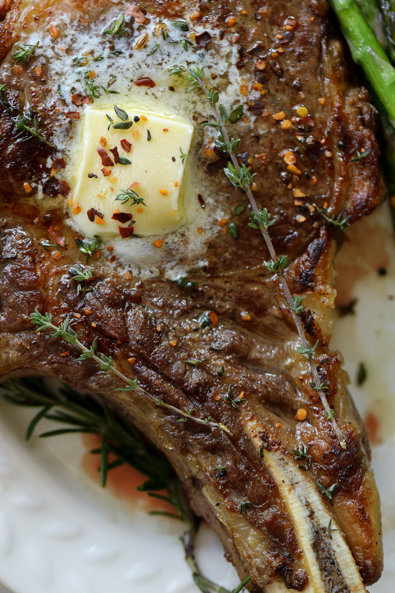 buttered, seasoned steak with butter and thyme on top