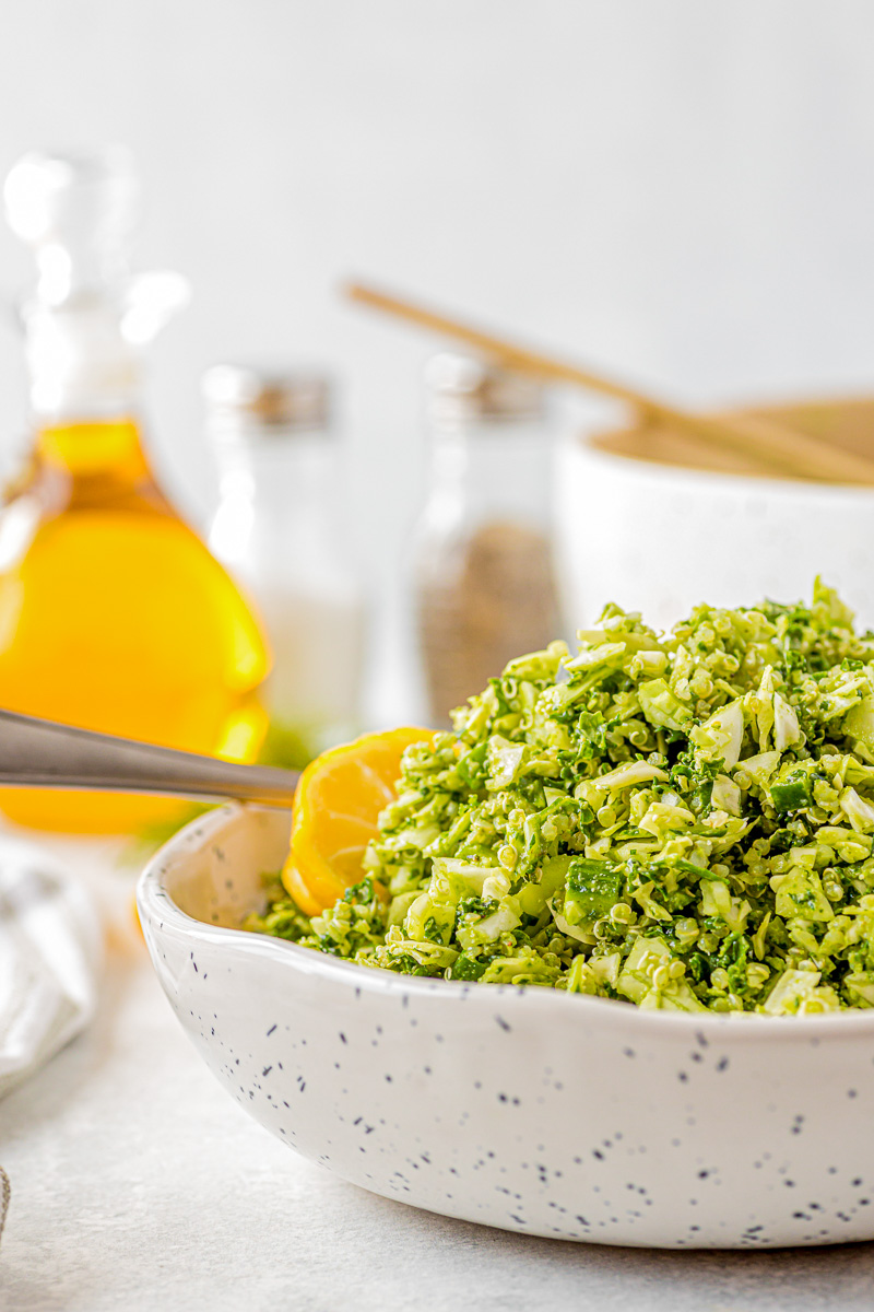 salad in a speckled bowl next to olive oil