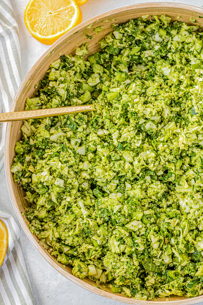 bowl of green goddess salad with a lemon wedge