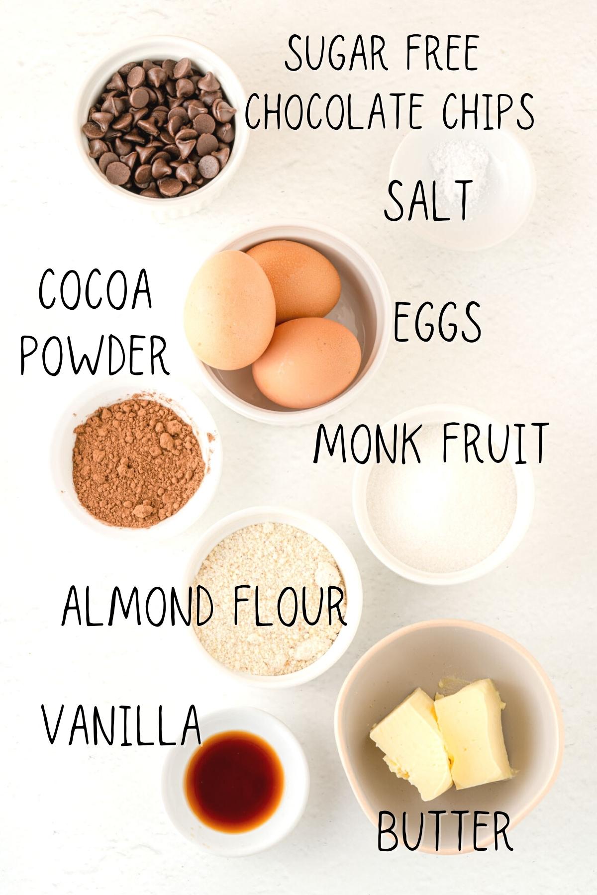 ingredients for sugar free keto brownies, including vanilla, cocoa powder, butter, almond flour, cocoa and sugar free chocolate chips