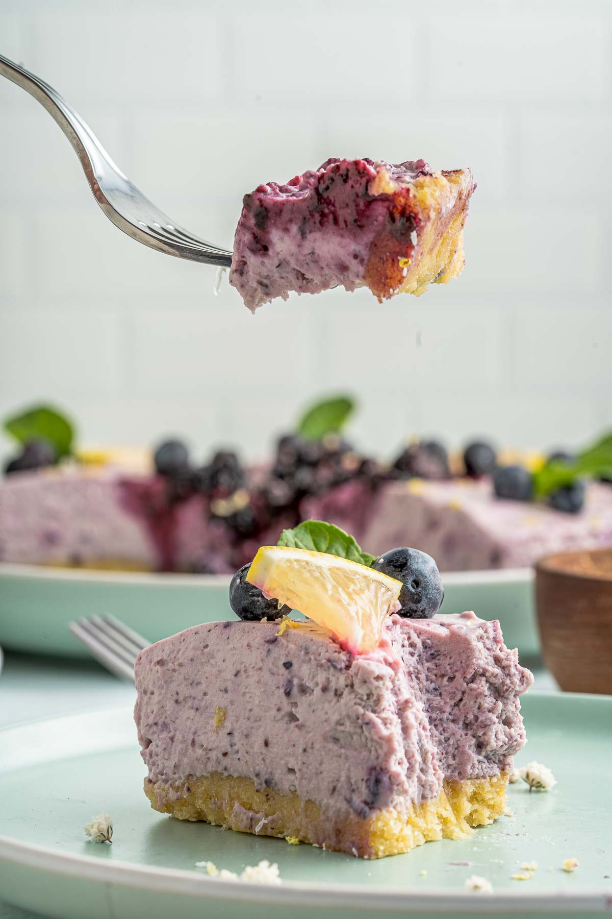 fork lifting a bite of blueberry no bake cheesecake