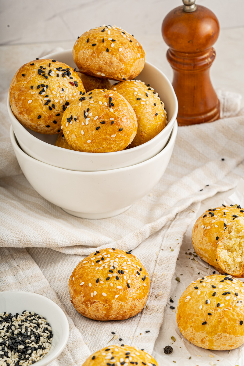 keto rolls with sesame seeds and butter on top