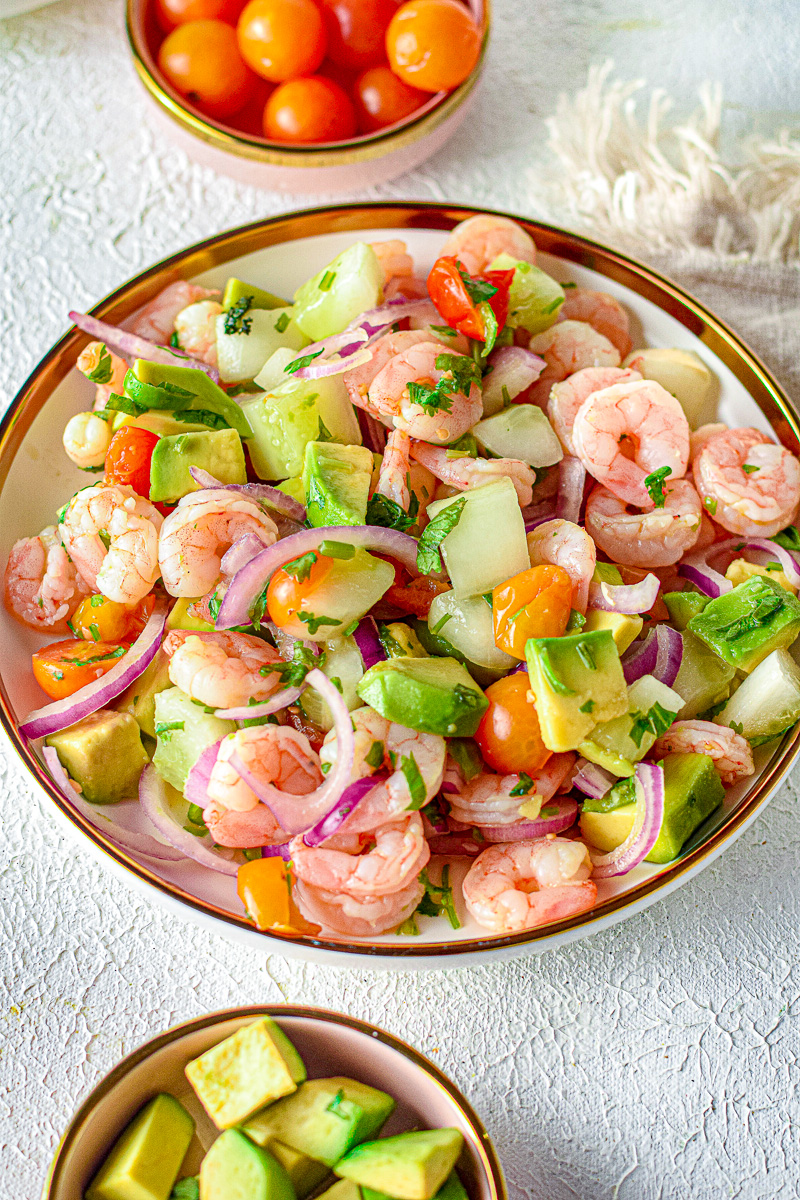 shrimp ceviche in a bowl with onion, cilantro, tomato, and avocado