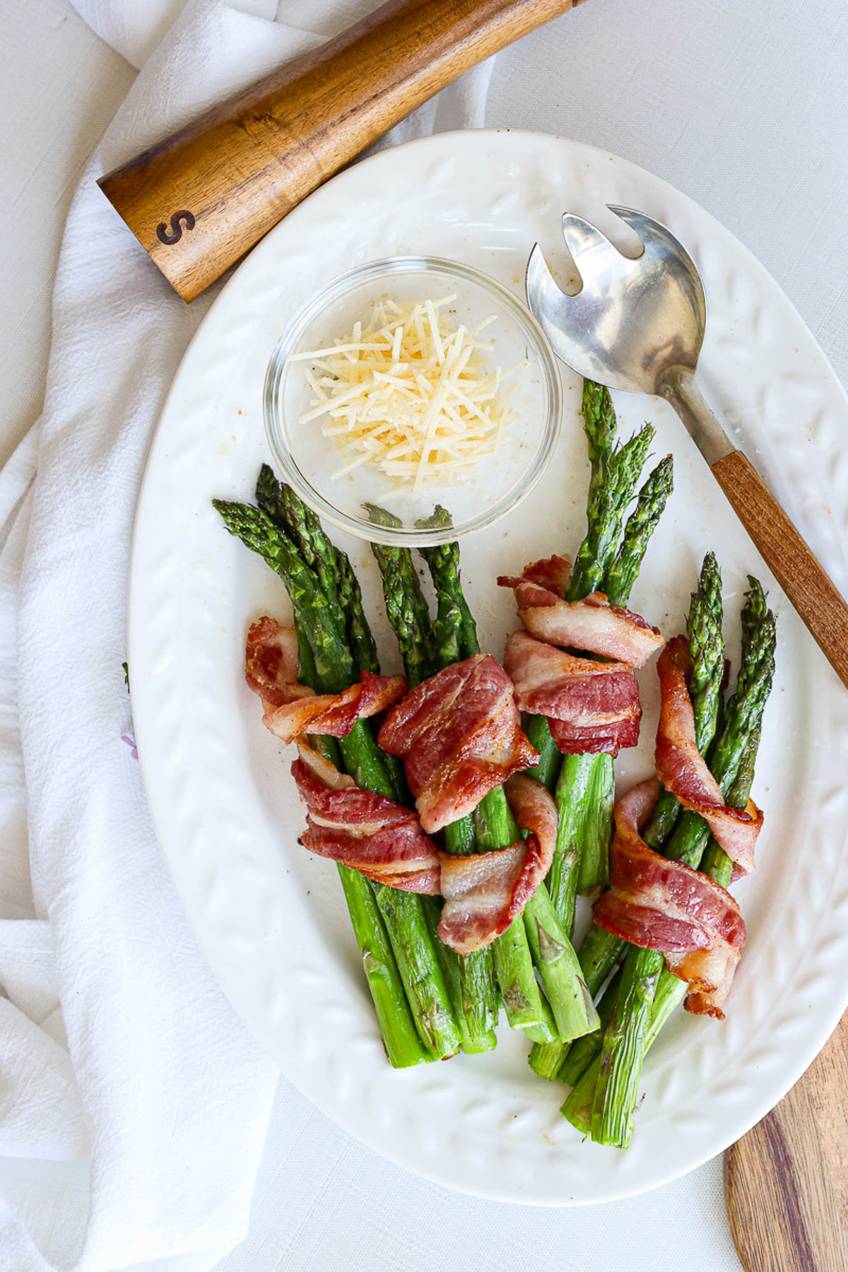 asparagus wrapped in bacon on a platter