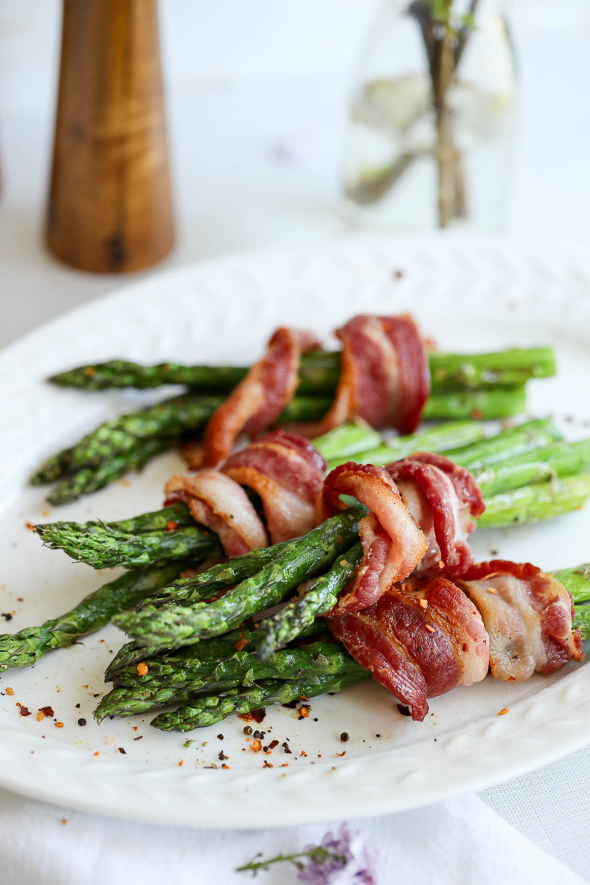 asparagus wrapped in crisp, cooked bacon on a platter