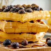 stack of three thick waffles with blueberries