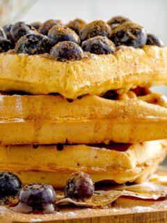 stack of three thick waffles with blueberries